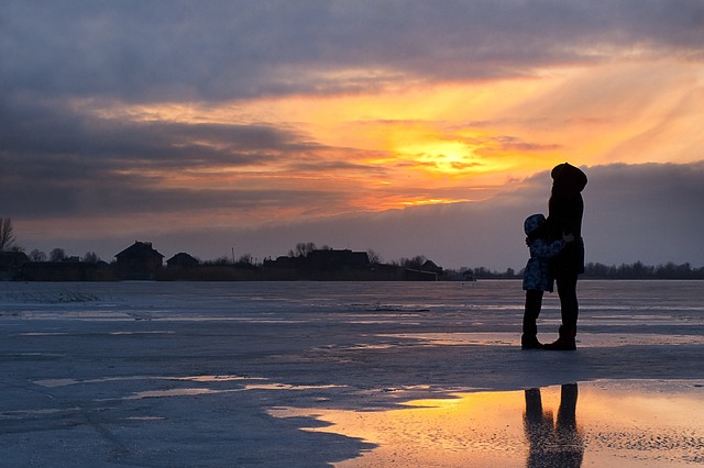 adult and child figure in a landscape in the sun down saying good morning messages