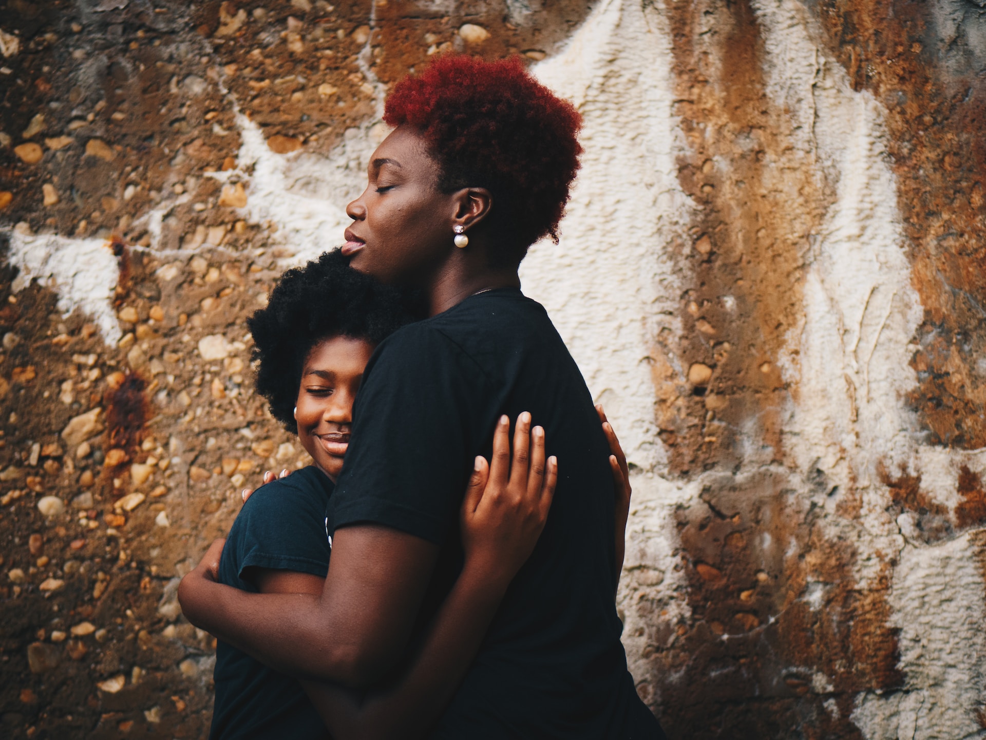 mother and daughter hugging each other wishing happy mother's day