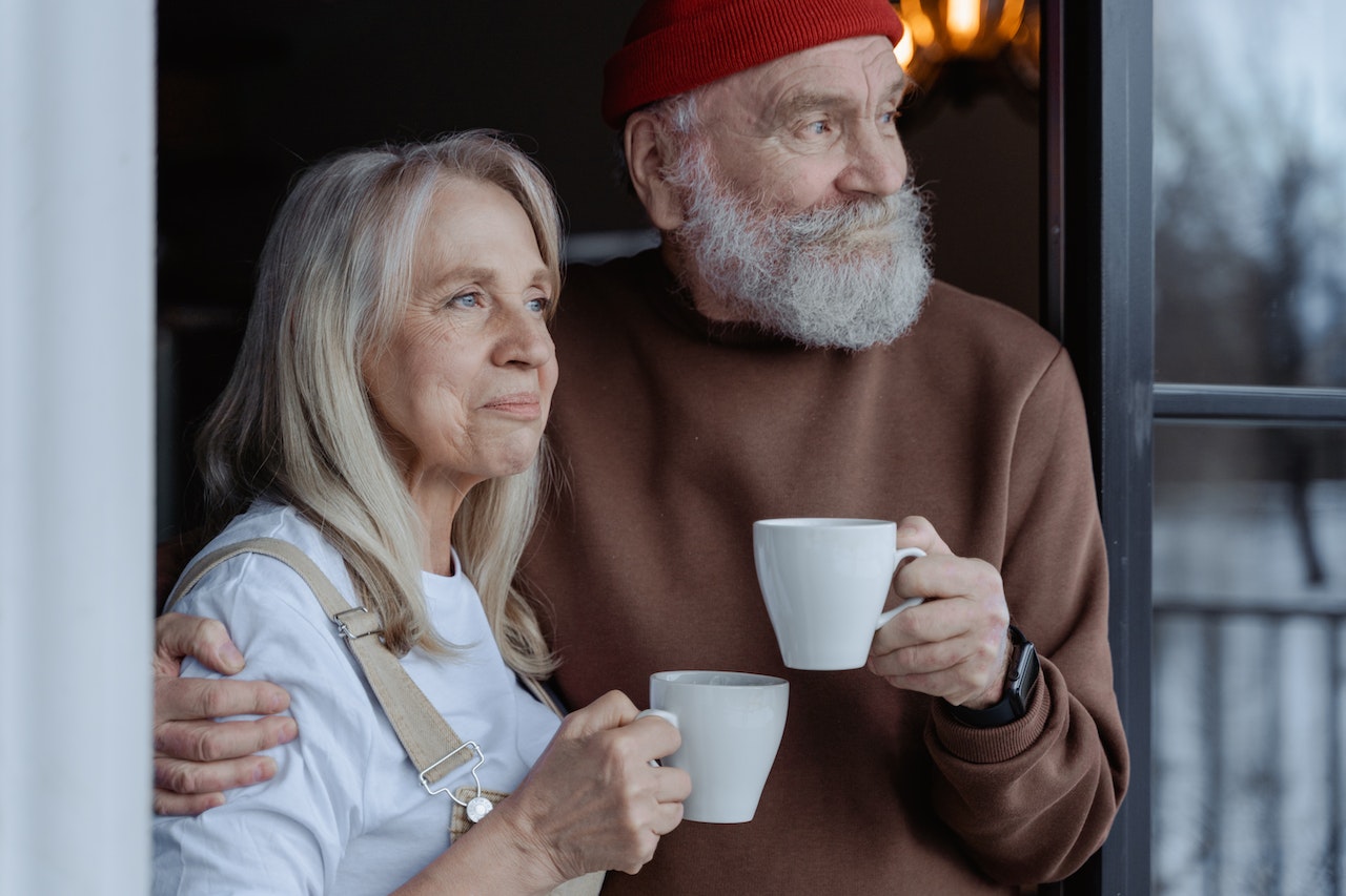 husband and wife taking coffee and gazing outside the window after sending happy valentines day husband