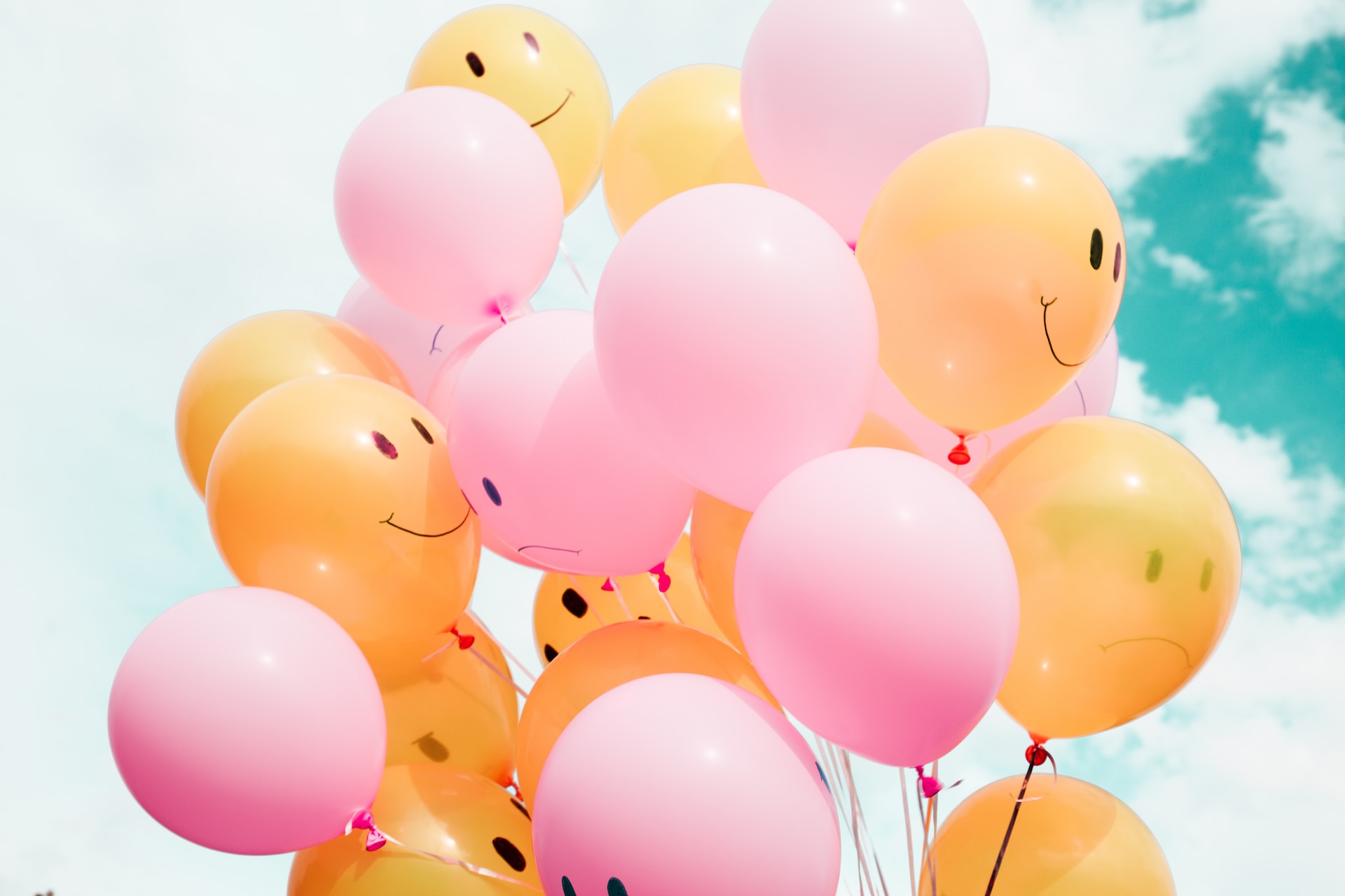pink and yellow balloons with smiles and positive messages
