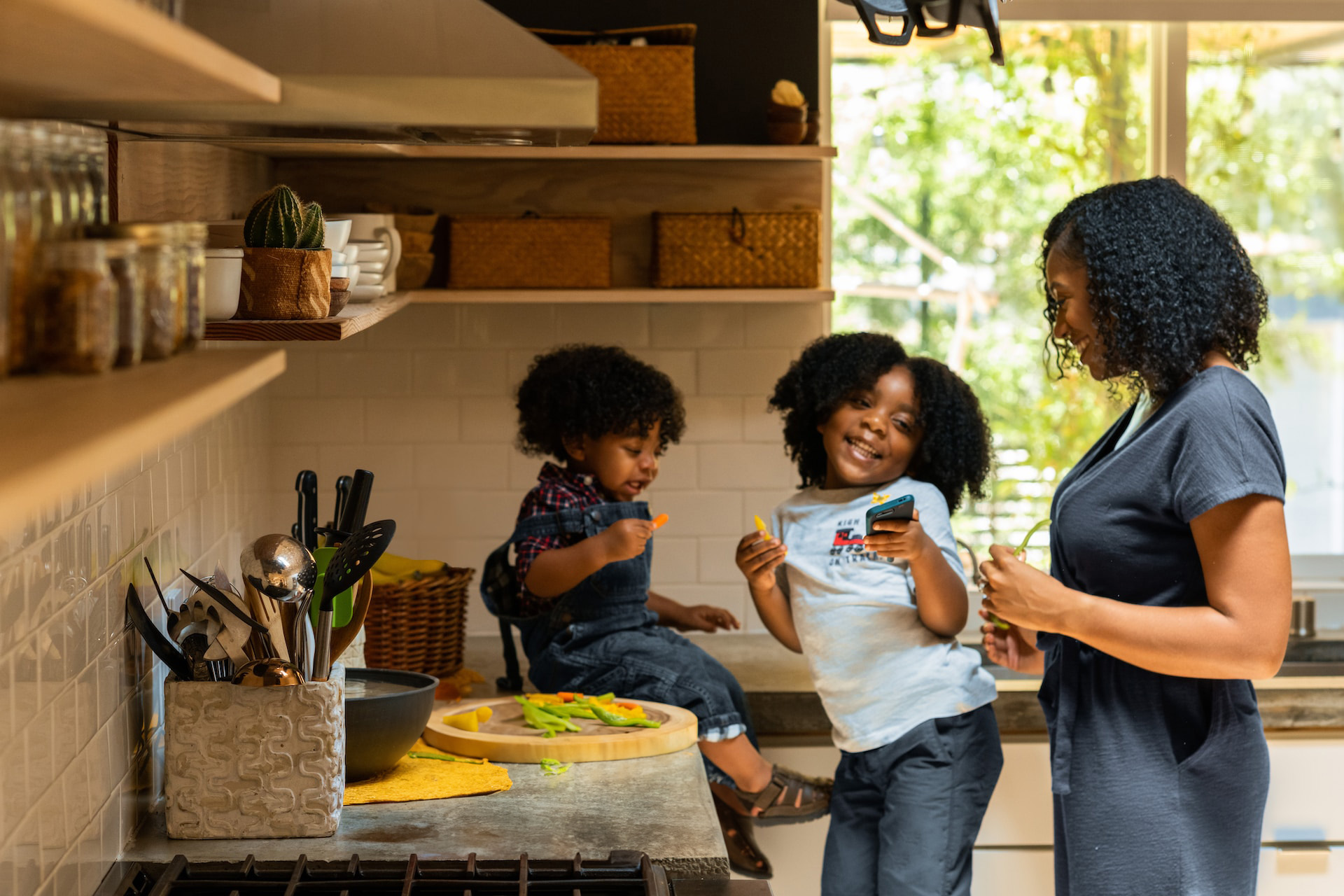 mother and two daughters in the kitchen saying happy mother's day wishes