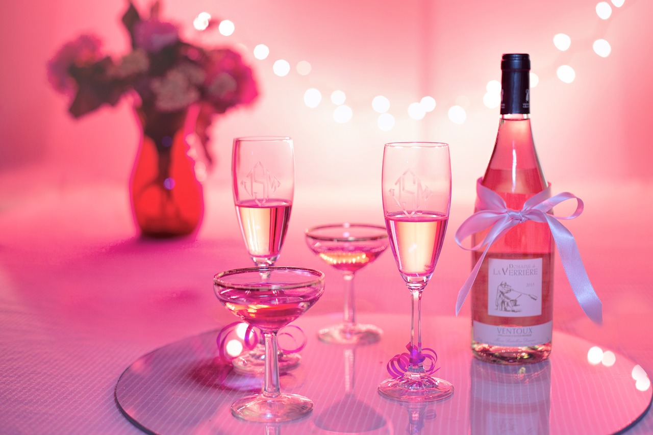 pink wine and glasses in a pink room to send happy birthday girlfriend messages