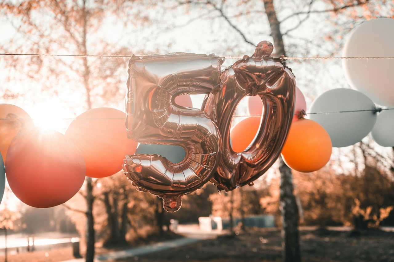 50 balloons in a outdoor party decoration for a brother's 50th birthday