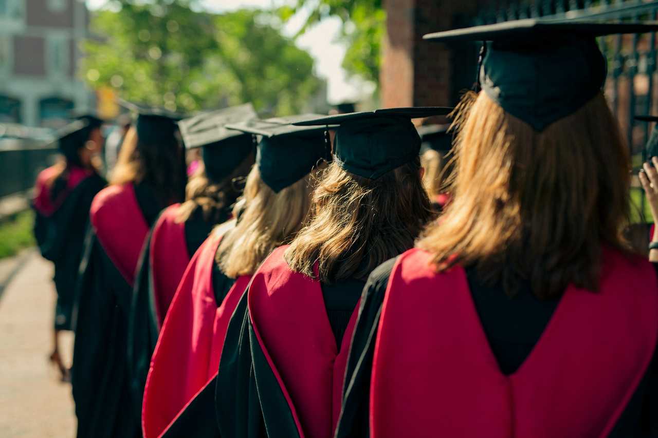 Graduating students in line waiting the ceremony wearing graduation outfits