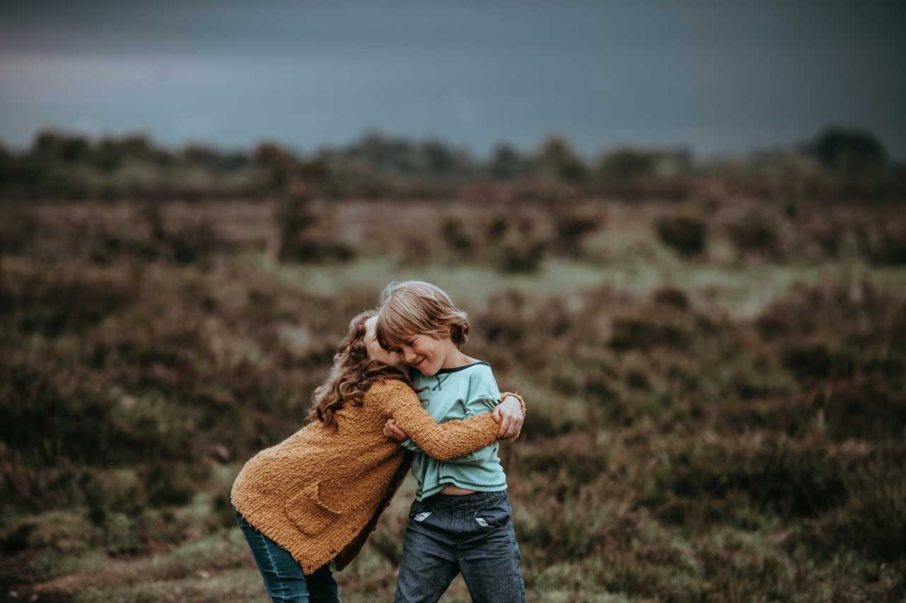 sister hugging brother in a semi arid landscape after getting messages with sister quotes