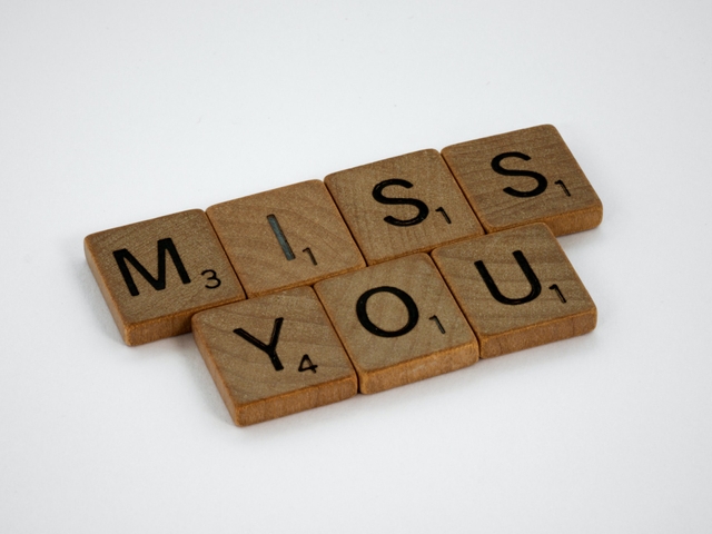 miss you message formed with scrabble wooden tiles