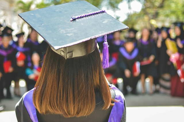 detail of a person graduating with friends