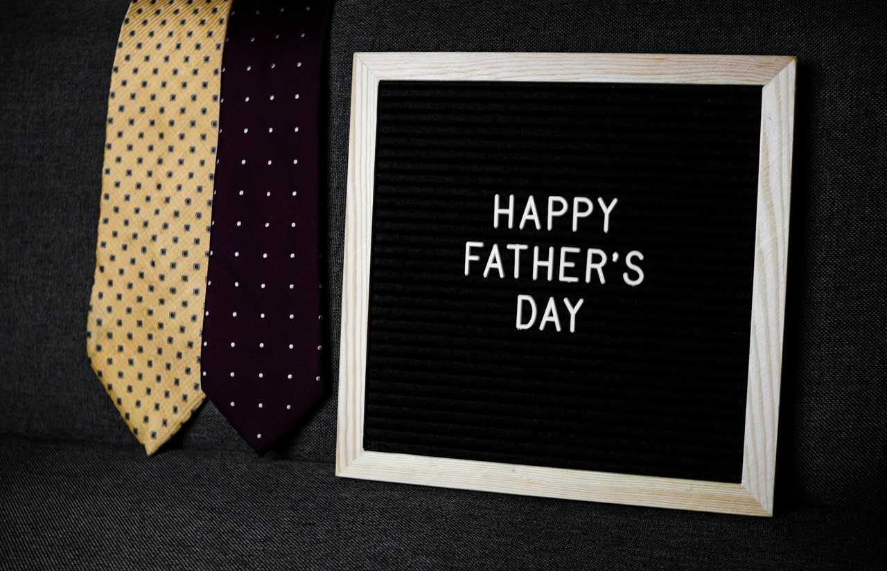 happy father's day message written in a table with two ties in the side