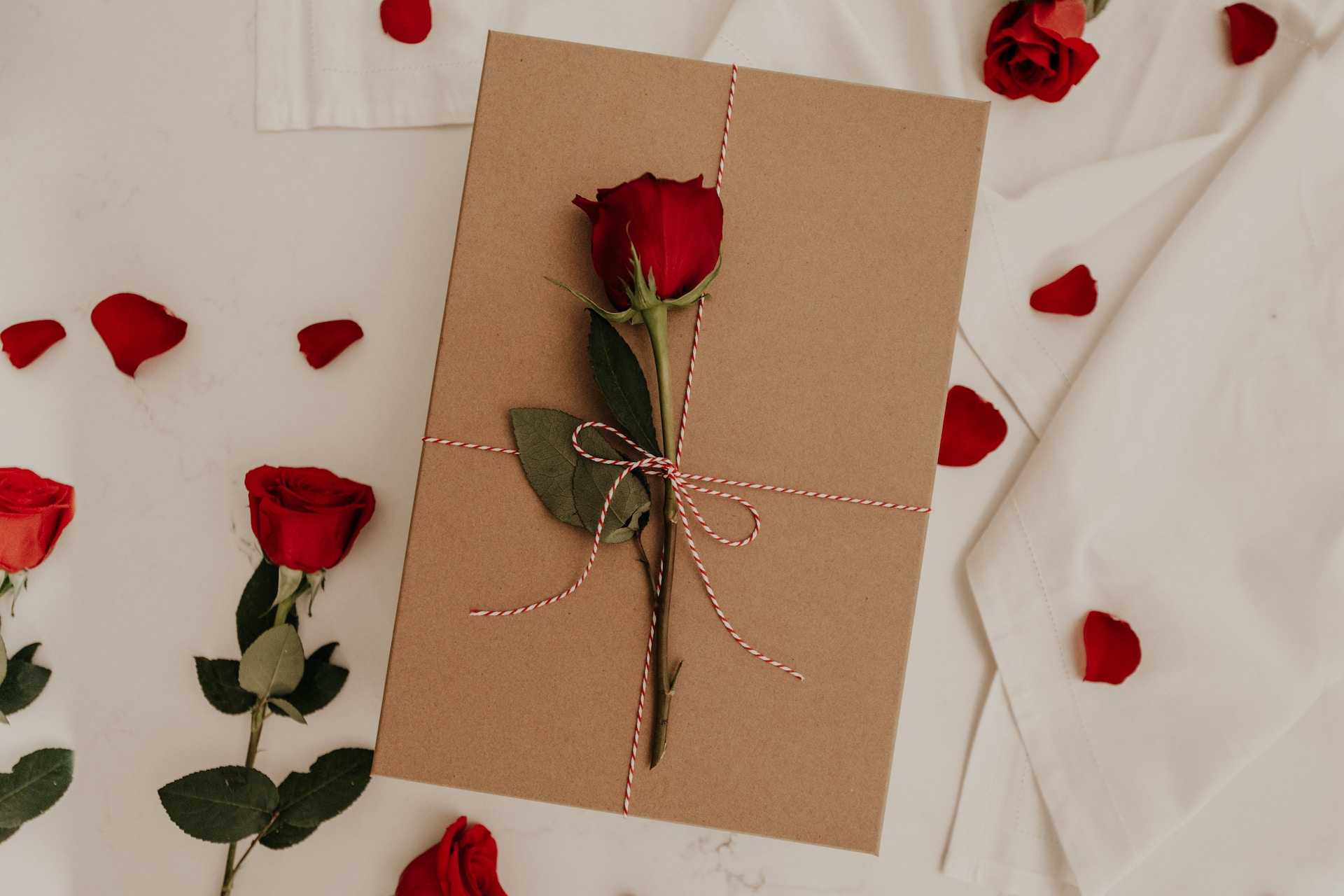 rose over an envelope with valentine's day quotes and messages for him