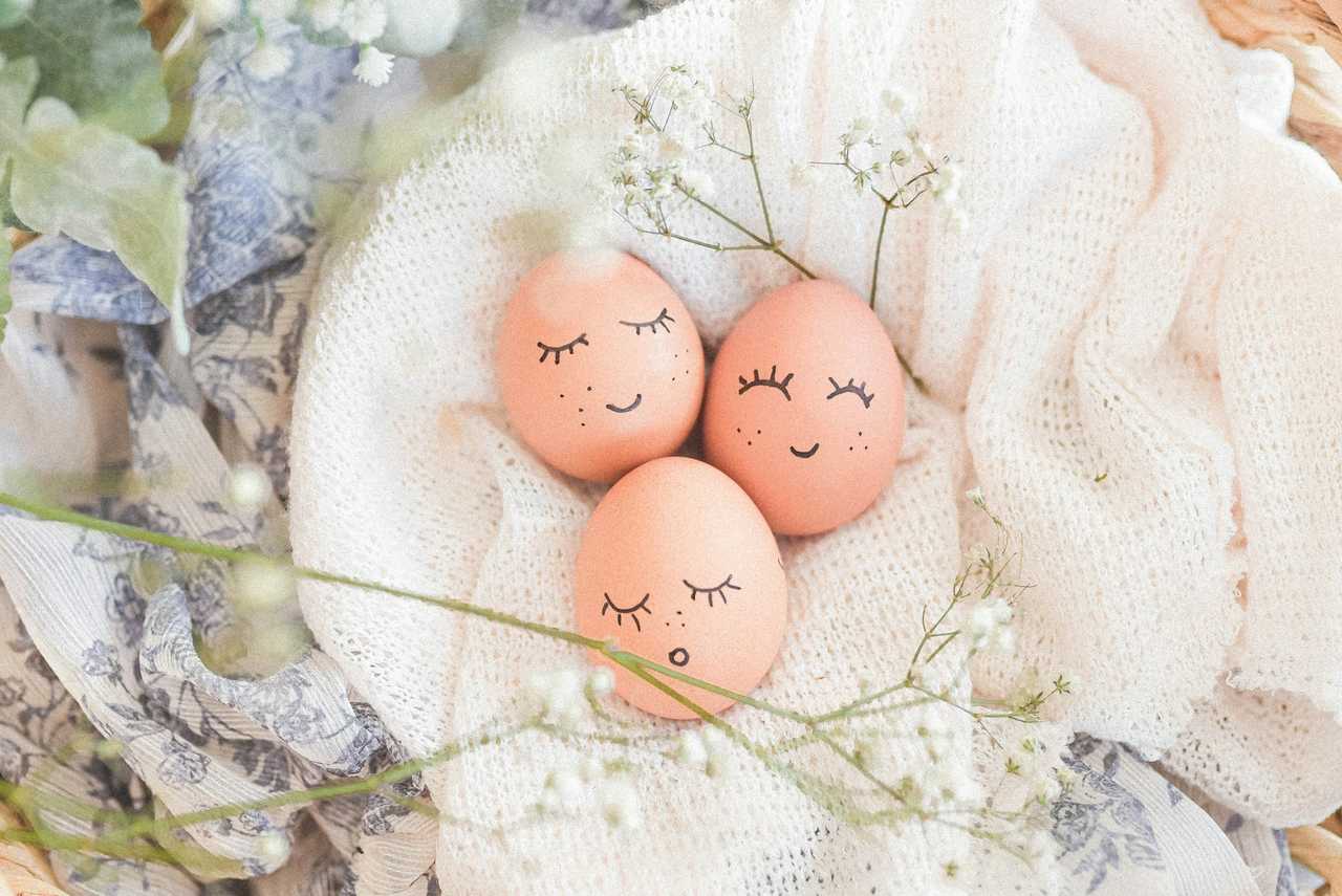 three eggs painted with smiles on a easter decor to send religious easter wishes