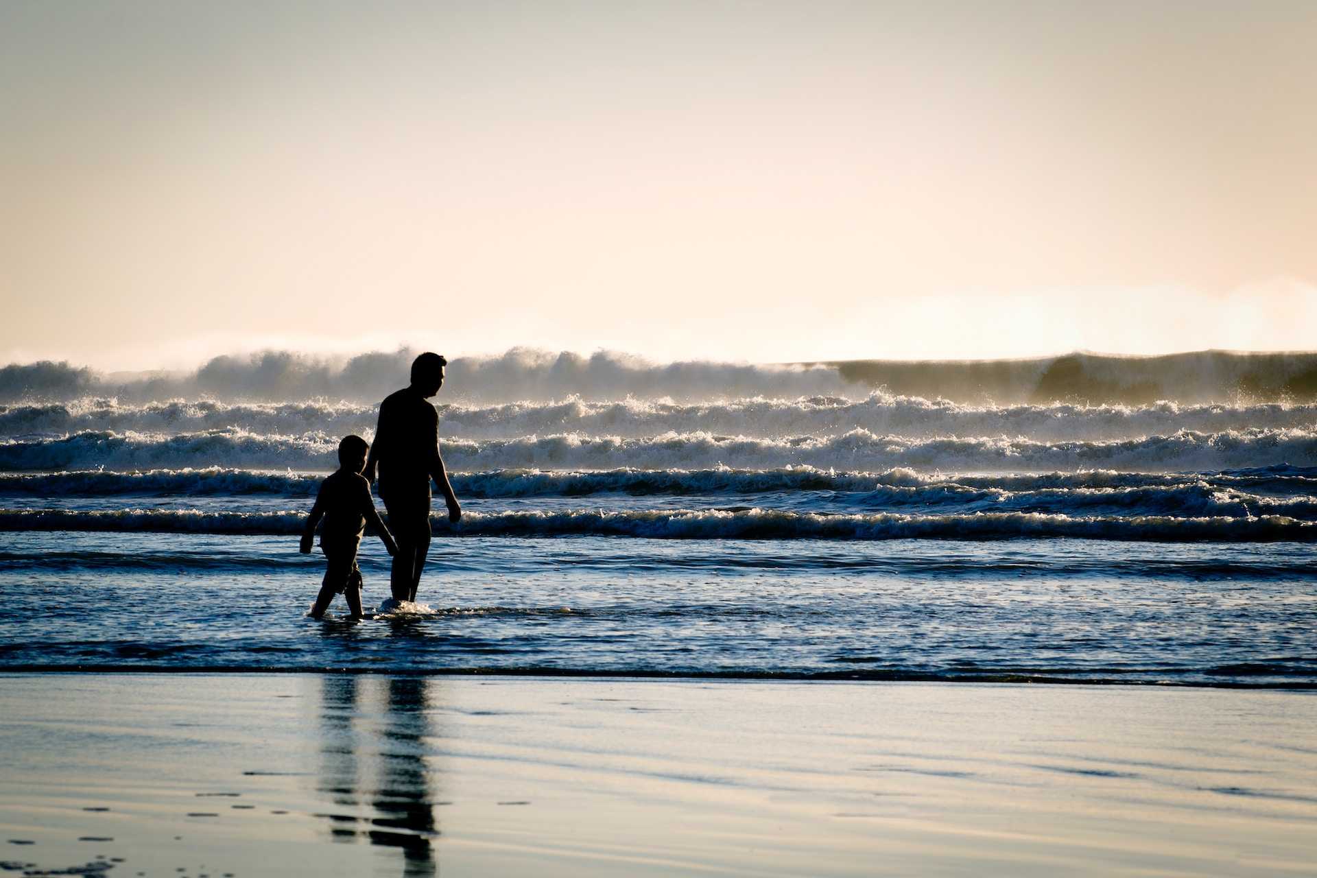 dad and son walking in the beach after saying good morning dad messages