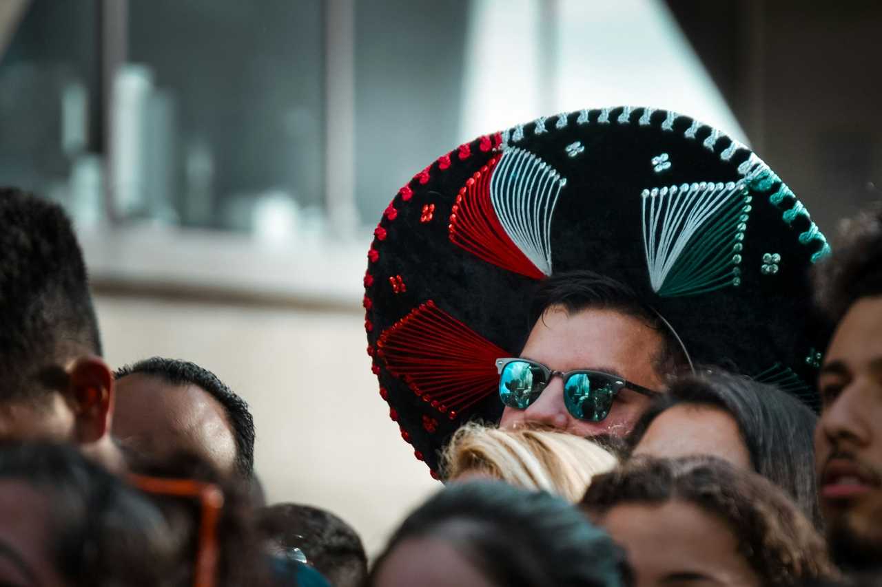 man wearing a sombrero in a crowd during cinco de mayo