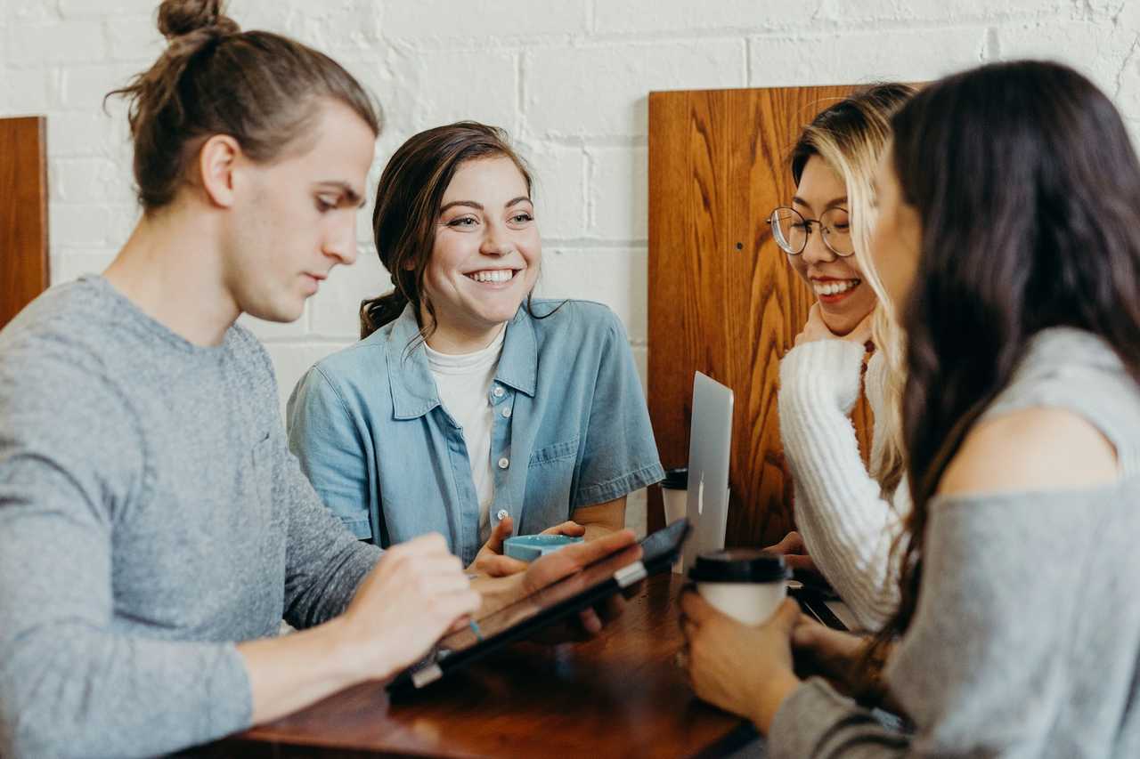 people smiling while writing greeting cards